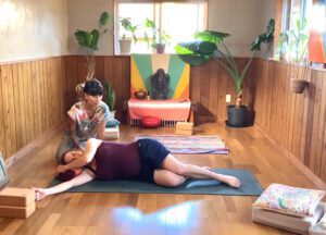 Expectant mothers practicing gentle prenatal yoga poses with instructor Tomomi.